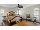 Relaxing main bedroom featuring dark hardwood floors, a ceiling fan and a decorative rug at 4810 W San Miguel St, Tampa, FL 33629
