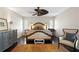 Inviting main bedroom featuring dark hardwood floors, a ceiling fan, and an area rug at 4810 W San Miguel St, Tampa, FL 33629