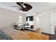 Comfortable main bedroom with dark hardwood floors, a ceiling fan, and sitting area at 4810 W San Miguel St, Tampa, FL 33629