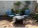 Cozy outdoor patio with fire pit, seating, lush plants, and privacy lattice at 4810 W San Miguel St, Tampa, FL 33629