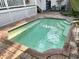 Private backyard swimming pool surrounded by a brick patio and lush landscaping providing a serene retreat at 4810 W San Miguel St, Tampa, FL 33629