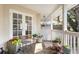 Relaxing porch with potted plants, seating, and a view of the surrounding property at 4810 W San Miguel St, Tampa, FL 33629