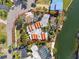 Aerial view of the waterfront property showcasing the unique roofline, mature landscaping, and seawall at 4811 Paradise S Way, St Petersburg, FL 33705