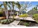 Landscaped backyard featuring a wooden pergola, a deck, and tropical plants at 4811 Paradise S Way, St Petersburg, FL 33705