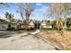 Charming home exterior with angular rooflines, lush greenery, and a spacious front yard at 4811 Paradise S Way, St Petersburg, FL 33705