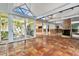 Spacious living room with tile flooring, fireplace and sliding glass door leading to lanai at 4811 Paradise S Way, St Petersburg, FL 33705
