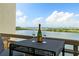 Balcony view overlooking the bay featuring seating, champagne and glasses for two at 5701 Mariner St # 606, Tampa, FL 33609