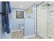 Blue bathroom with decorative tree sculpture, providing a tranquil and stylish space at 5701 Mariner St # 606, Tampa, FL 33609
