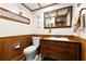 Cozy half-bathroom with wooden paneling, decorative mirror, and unique wooden vanity with drawers at 5701 Mariner St # 606, Tampa, FL 33609