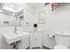 Well-lit bathroom with a modern sink, toilet, and glass-enclosed shower at 5701 Mariner St # 606, Tampa, FL 33609