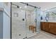 Modern bathroom featuring a glass-enclosed shower with a wooden bench and stylish vanity at 5701 Mariner St # 606, Tampa, FL 33609