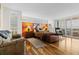 Bright bedroom with hardwood floors, large windows, and a decorative accent wall behind the bed at 5701 Mariner St # 606, Tampa, FL 33609