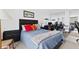 Cozy bedroom with a blue quilt bed, nightstand, mirrored wall, and built in desk at 5701 Mariner St # 606, Tampa, FL 33609