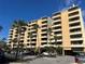 Multi-story residential building with multiple balconies and palm trees in the foreground against a clear blue sky at 5701 Mariner St # 606, Tampa, FL 33609