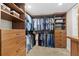 Spacious walk-in closet with custom wood shelving and drawers for organized storage at 5701 Mariner St # 606, Tampa, FL 33609