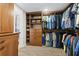 Walk-in closet with custom wood shelving and racks for ample storage and organization at 5701 Mariner St # 606, Tampa, FL 33609