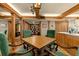 Dining room featuring a table with green upholstered chairs, wooden beams, and view to kitchen at 5701 Mariner St # 606, Tampa, FL 33609