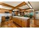 Open kitchen with wood cabinetry, marble countertops, stainless steel appliances, and adjacent dining area at 5701 Mariner St # 606, Tampa, FL 33609