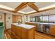 Gourmet kitchen with an island, stainless steel appliances, wooden cabinets and a wine cooler at 5701 Mariner St # 606, Tampa, FL 33609