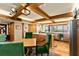 Open-concept kitchen with an island, table with green chairs and lots of wooden features at 5701 Mariner St # 606, Tampa, FL 33609