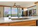 Kitchen sink with marble countertops overlooks a stunning view of the water at 5701 Mariner St # 606, Tampa, FL 33609