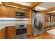 Modern kitchen with stainless steel appliances, wooden cabinets, and light countertops at 5701 Mariner St # 606, Tampa, FL 33609