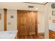 Large wooden pantry doors next to an island with light countertops in the kitchen at 5701 Mariner St # 606, Tampa, FL 33609