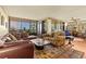 Bright living room with floor-to-ceiling windows offering views, multiple seating areas, and hardwood floors at 5701 Mariner St # 606, Tampa, FL 33609