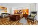 Bright main bedroom with hardwood floors, shutters and painted feature wall behind bed at 5701 Mariner St # 606, Tampa, FL 33609