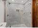 Walk-in shower featuring decorative tile, glass door, and a modern shower head at 5701 Mariner St # 606, Tampa, FL 33609