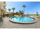 Inviting round pool with seating, umbrellas and direct access to the bay at 5701 Mariner St # 606, Tampa, FL 33609