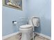 Accessible toilet with grab bars and blue walls in this bathroom at 5701 Mariner St # 606, Tampa, FL 33609