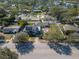 Neighborhood aerial view showcasing the home, lush landscaping, and nearby lake at 6342 5Th N Ave, St Petersburg, FL 33710