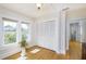 Light-filled bedroom featuring hardwood floors, a closet and two windows overlooking lush greenery at 6342 5Th N Ave, St Petersburg, FL 33710