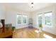 Bright room featuring warm-toned hardwood floors and lots of natural light from 2 large windows at 6342 5Th N Ave, St Petersburg, FL 33710