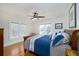 Bright bedroom featuring large windows, hardwood floors, a ceiling fan, and a comfortable king-sized bed at 6342 5Th N Ave, St Petersburg, FL 33710