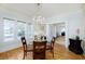Bright dining room with chandelier, hardwood floors, and a view of the exterior at 6342 5Th N Ave, St Petersburg, FL 33710