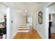 Hallway featuring hardwood floors, white trim and staircase with lots of natural light at 6342 5Th N Ave, St Petersburg, FL 33710