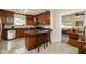 Charming kitchen features dark wood cabinets, granite counters, stainless appliances, and a cozy breakfast bar at 6342 5Th N Ave, St Petersburg, FL 33710