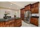 Kitchen featuring stainless steel refrigerator, granite countertops, and ample dark wood cabinets at 6342 5Th N Ave, St Petersburg, FL 33710