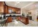 Well-lit kitchen featuring rich wood cabinetry, granite countertops, and modern stainless steel appliances at 6342 5Th N Ave, St Petersburg, FL 33710