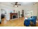 Bright living room boasts hardwood floors, fireplace, and natural light at 6342 5Th N Ave, St Petersburg, FL 33710