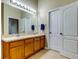 Well-lit bathroom with double sinks, a large mirror, and neutral tones, offering a serene and functional space at 7510 Red Mill Cir, New Port Richey, FL 34653
