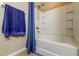 Clean bathroom featuring a shower-tub combination with a shower curtain, and a neatly hung towel at 7510 Red Mill Cir, New Port Richey, FL 34653