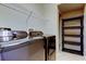 Laundry room with front-loading machines, shelving, and clean lines, designed for efficiency and organization at 7510 Red Mill Cir, New Port Richey, FL 34653