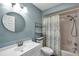 Bathroom with a light blue wall, white vanity, and shower-tub combo at 1003 De Soto Dr # 2, Dunedin, FL 34698