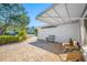 Cozy back patio area with a seating, surrounded by mature trees and landscaping at 1024 Brae Ct, Palm Harbor, FL 34684