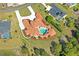 Aerial view of a sprawling estate featuring a private pool, lush landscaping, and a tile roof at 11158 Warm Wind Way, Weeki Wachee, FL 34613