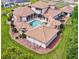 Mediterranean-style home featuring a pool, terracotta roof, and beautifully landscaped grounds at 11158 Warm Wind Way, Weeki Wachee, FL 34613