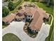 Sprawling luxury home featuring a terracotta roof, circular driveway, and meticulous landscaping at 11158 Warm Wind Way, Weeki Wachee, FL 34613